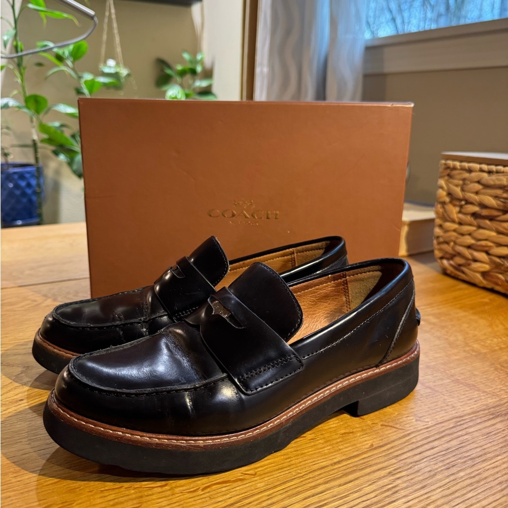 COACH-Black patten leather penny loafers with metal logo detail